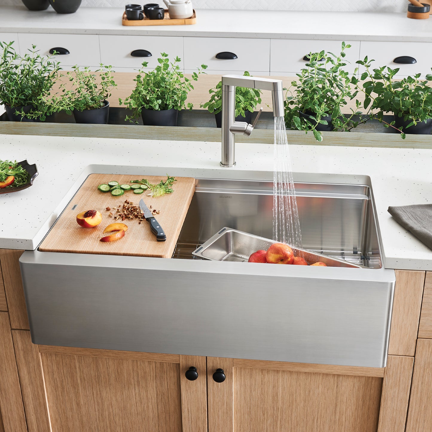 BLANCO Quatrus R15 Ergon 33" Single Bowl Apron-Front Stainless Steel Farmhouse Sink in a modern kitchen workspace
