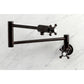 Kingston Brass KS4103BX Metropolitan Wall Mount Pot Filler Faucet, Antique Brass, with folding swing arms for easy access.