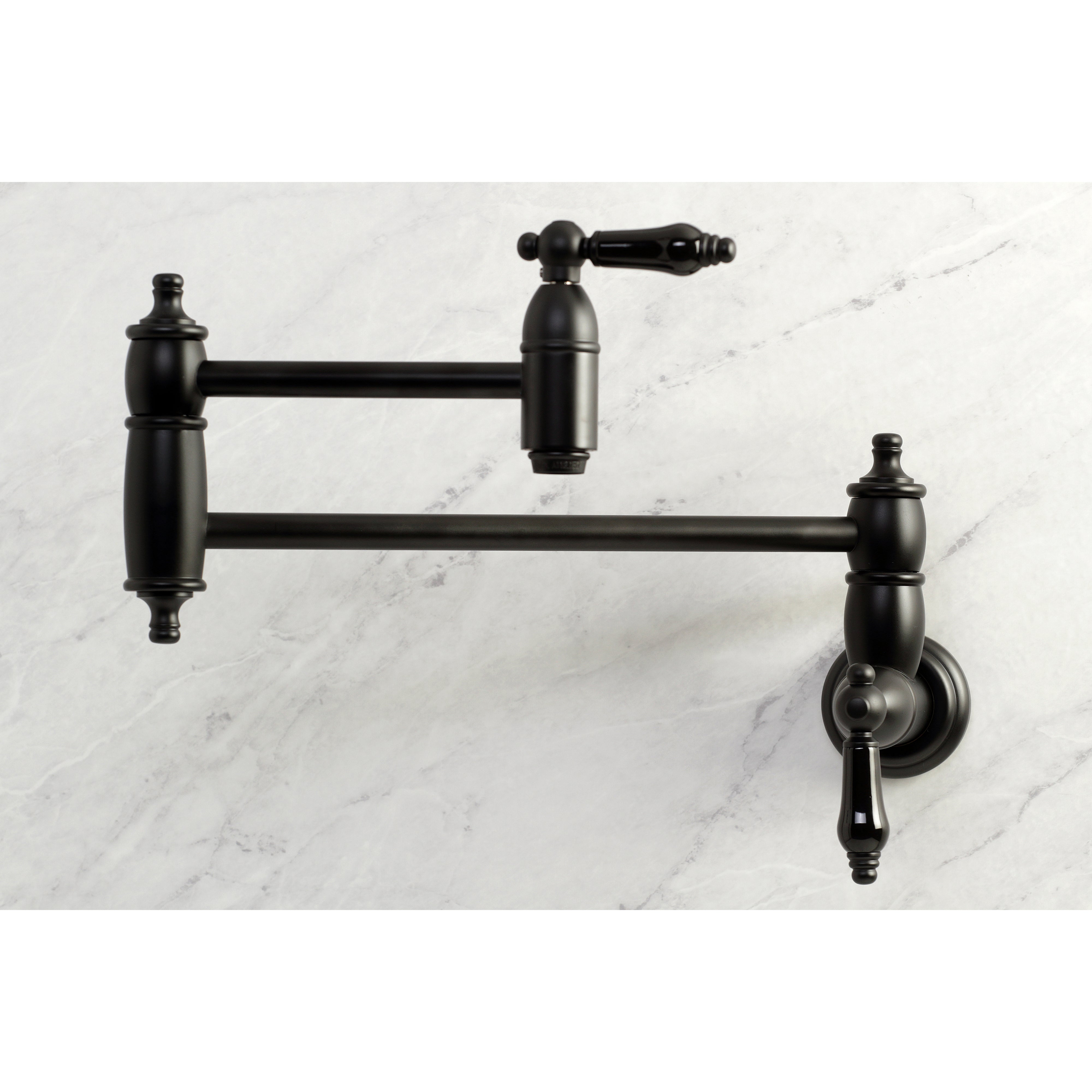 Kingston Brass KS3103PKL Duchess Wall Mount Pot Filler Faucet, Antique Brass on marble background.