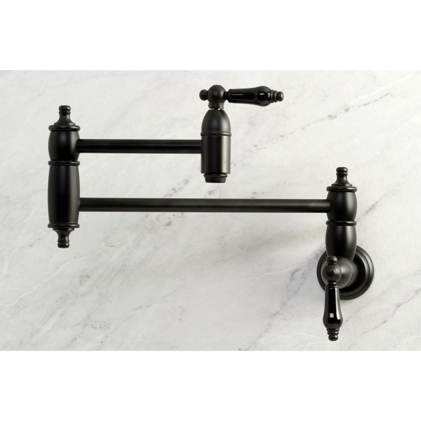 Kingston Brass KS3103PKL Duchess Wall Mount Pot Filler Faucet, Antique Brass on marble background.