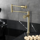 Kingston Brass KS4703CG Fuller Deck Mount Pot Filler Faucet, Antique Brass with foldable swing arms on kitchen counter.
