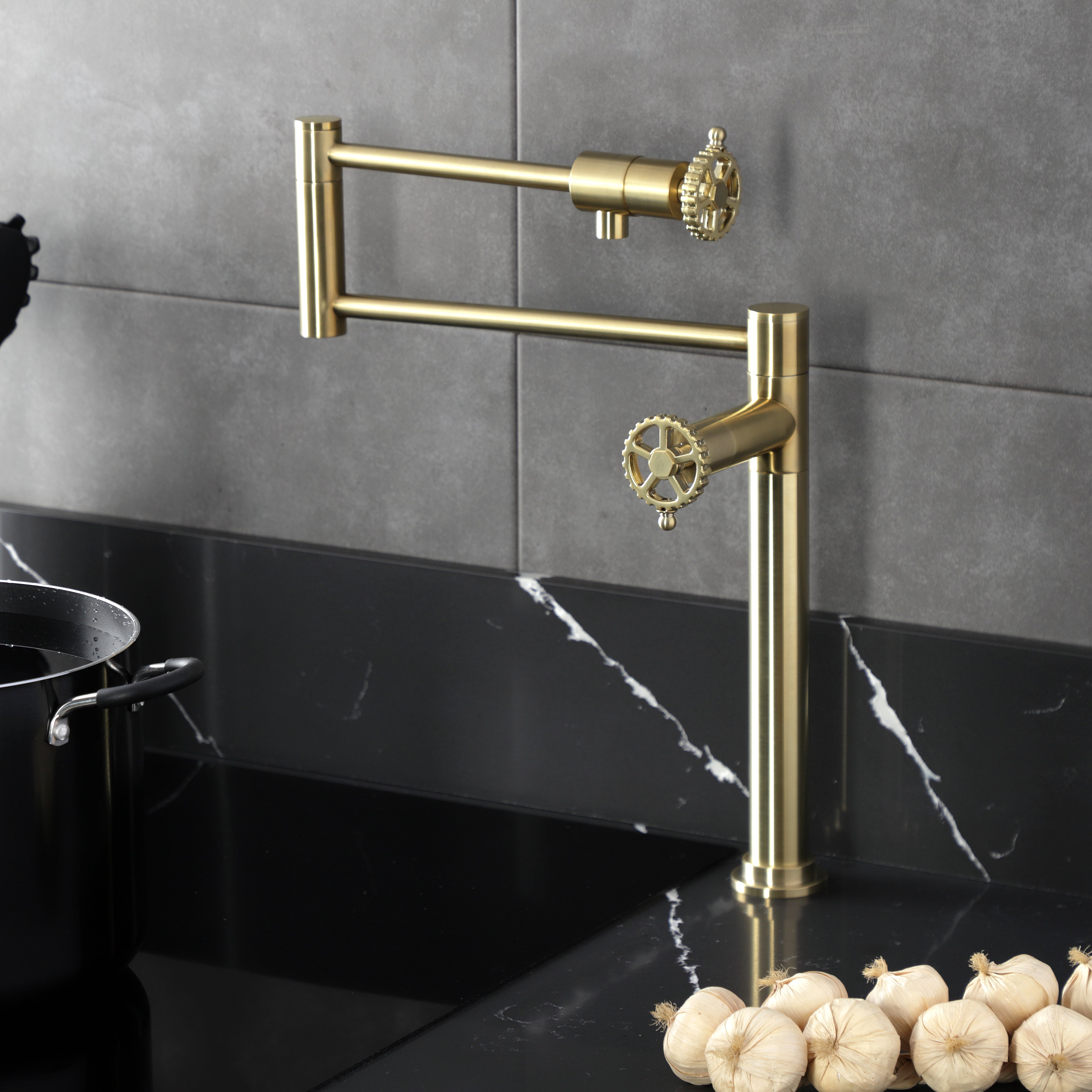 Kingston Brass KS4703CG Fuller Deck Mount Pot Filler Faucet, Antique Brass with foldable swing arms on kitchen counter.