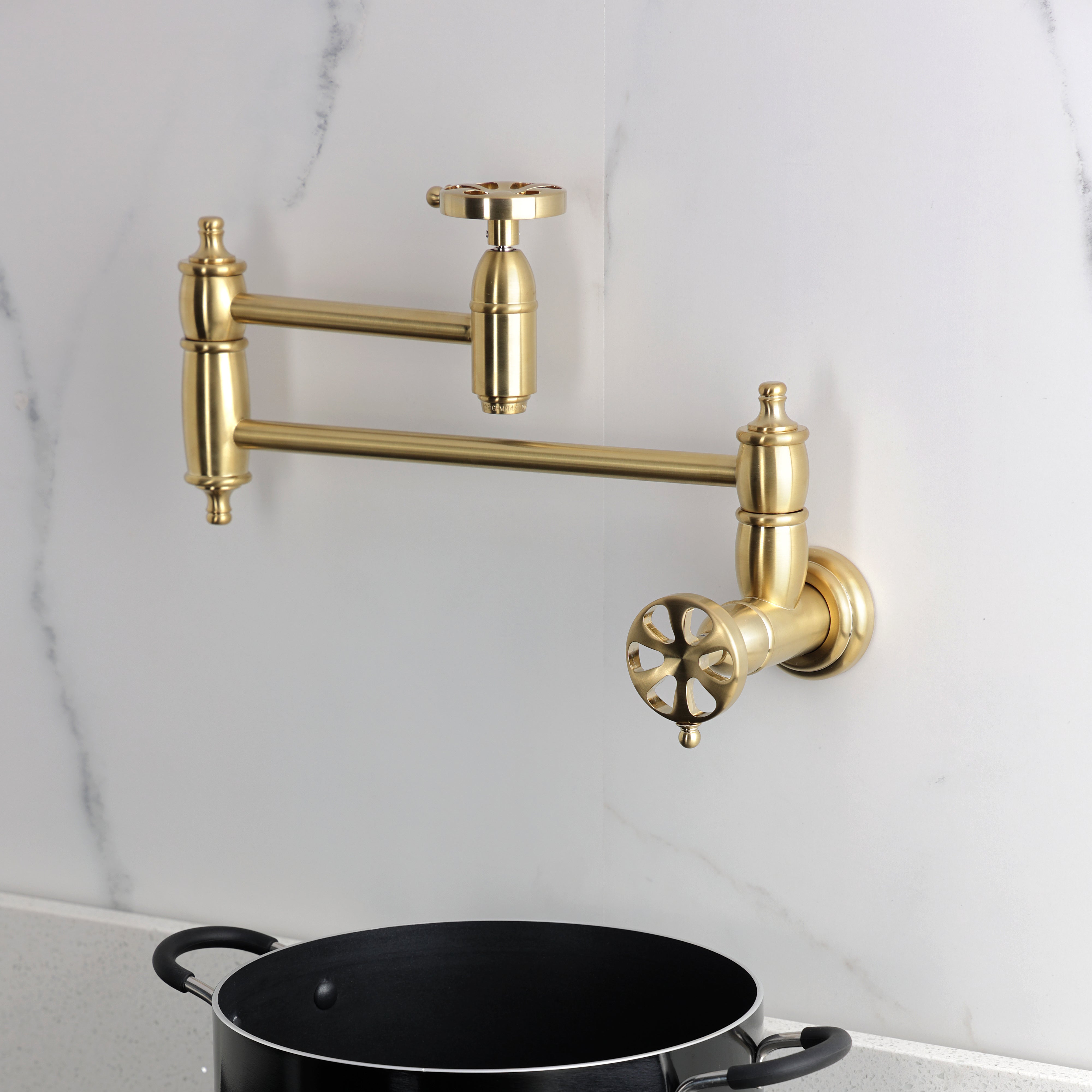 Kingston Brass KS3103RX Belknap Wall Mount Pot Filler Faucet, Antique Brass on a modern kitchen wall.