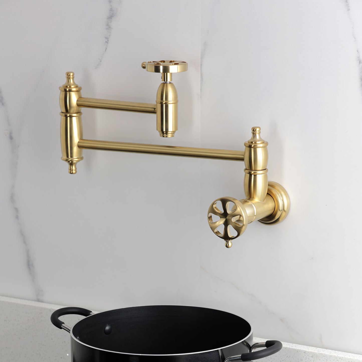 Kingston Brass KS3103RX Belknap Wall Mount Pot Filler Faucet, Antique Brass on a modern kitchen wall.
