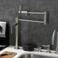 Kingston Brass KS4703DL Concord Deck Mount Pot Filler Faucet, Antique Brass placed on kitchen countertop.