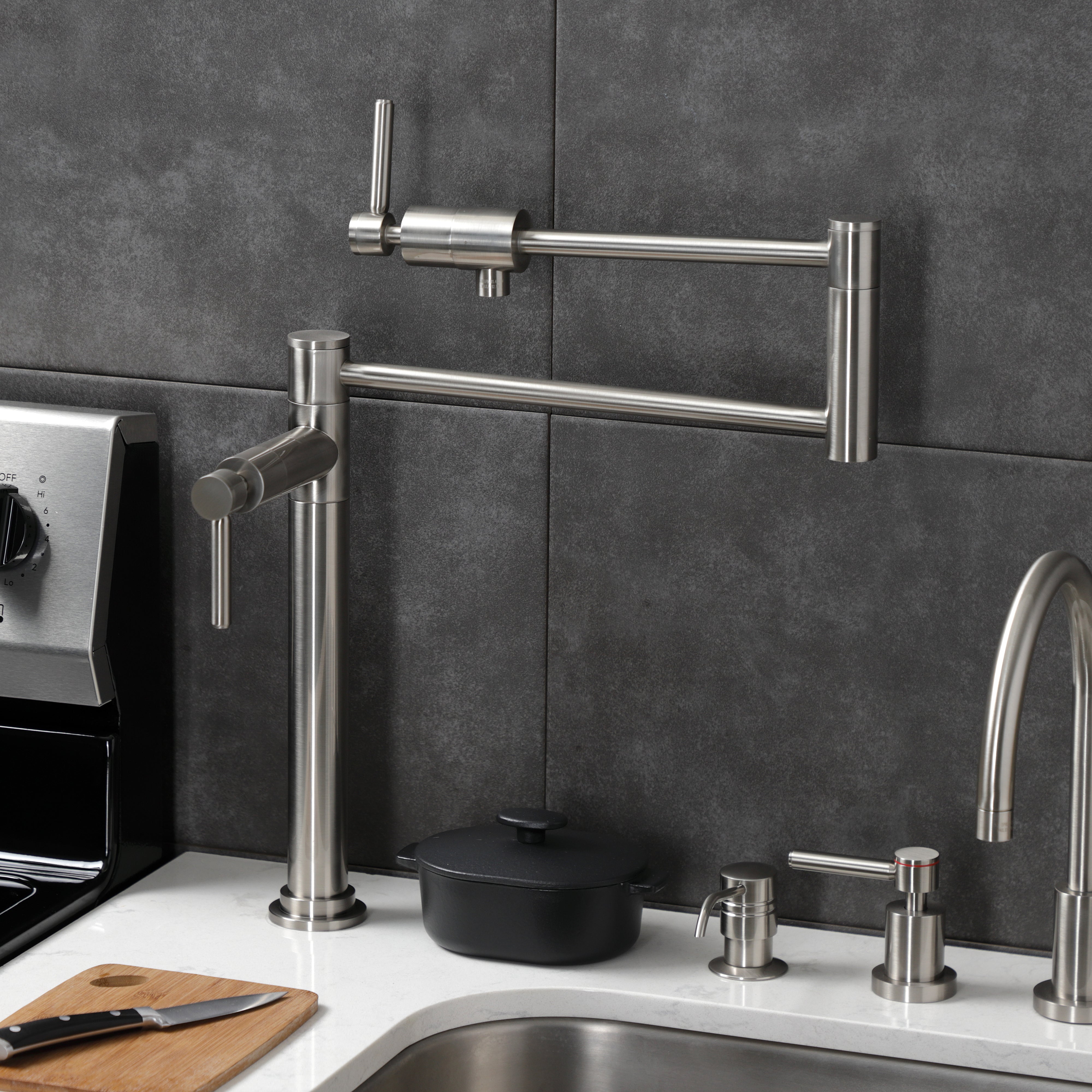 Kingston Brass KS4703DL Concord Deck Mount Pot Filler Faucet, Antique Brass placed on kitchen countertop.