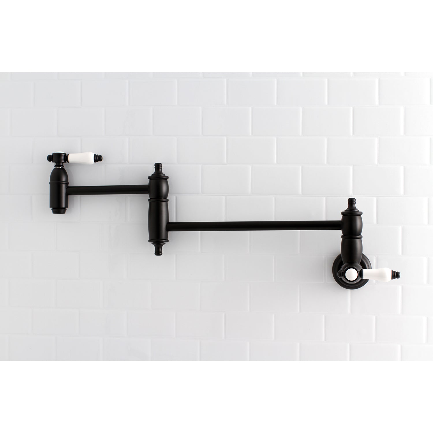 Kingston Brass KS3103BPL Bel-Air Wall Mount Pot Filler Faucet, Antique Brass on a white tiled wall.