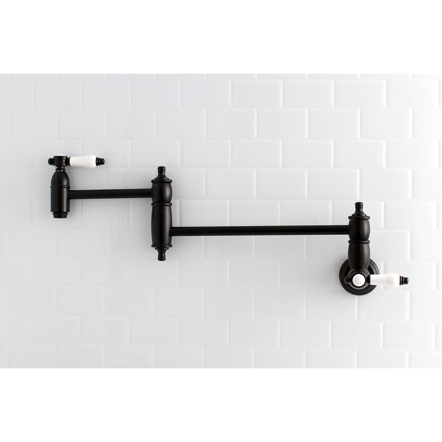 Kingston Brass KS3103BPL Bel-Air Wall Mount Pot Filler Faucet, Antique Brass on a white tiled wall.