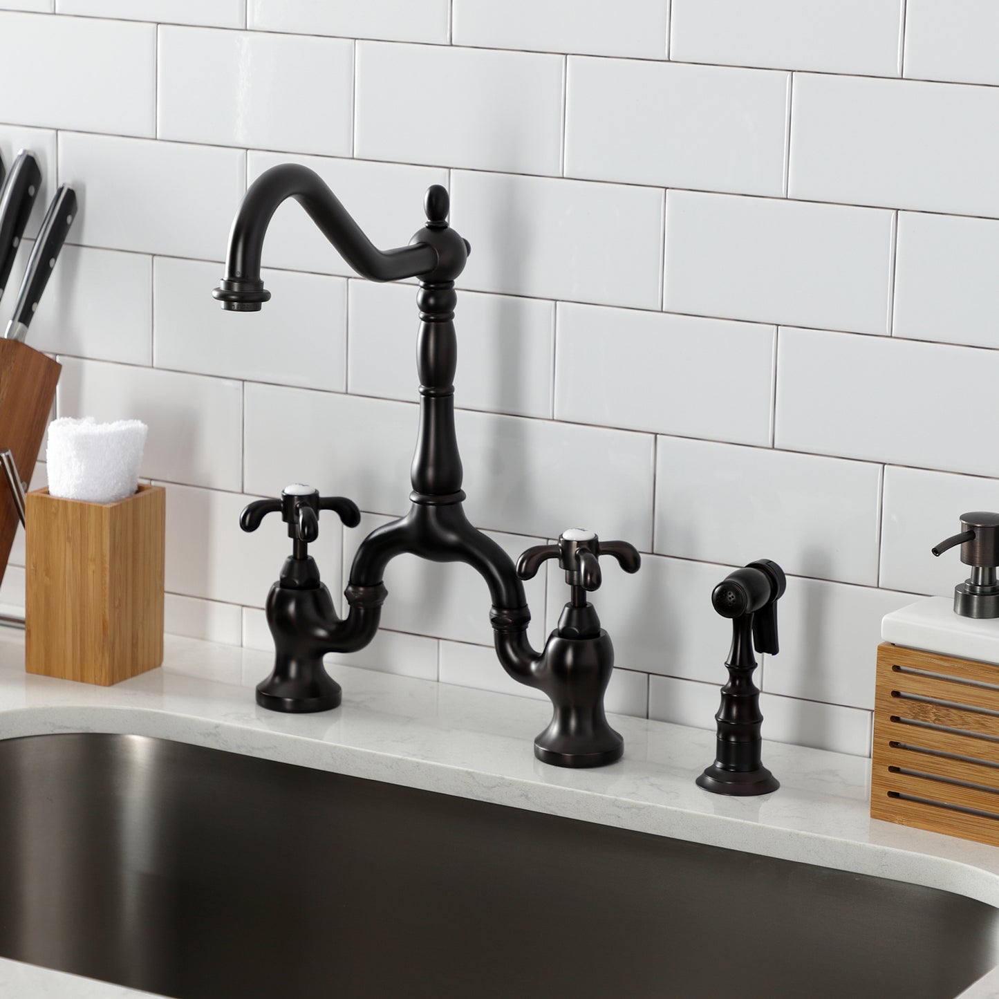 Kingston KS7753TXBS French Country Bridge Kitchen Faucet with Brass Sprayer, Antique Brass in a kitchen setting