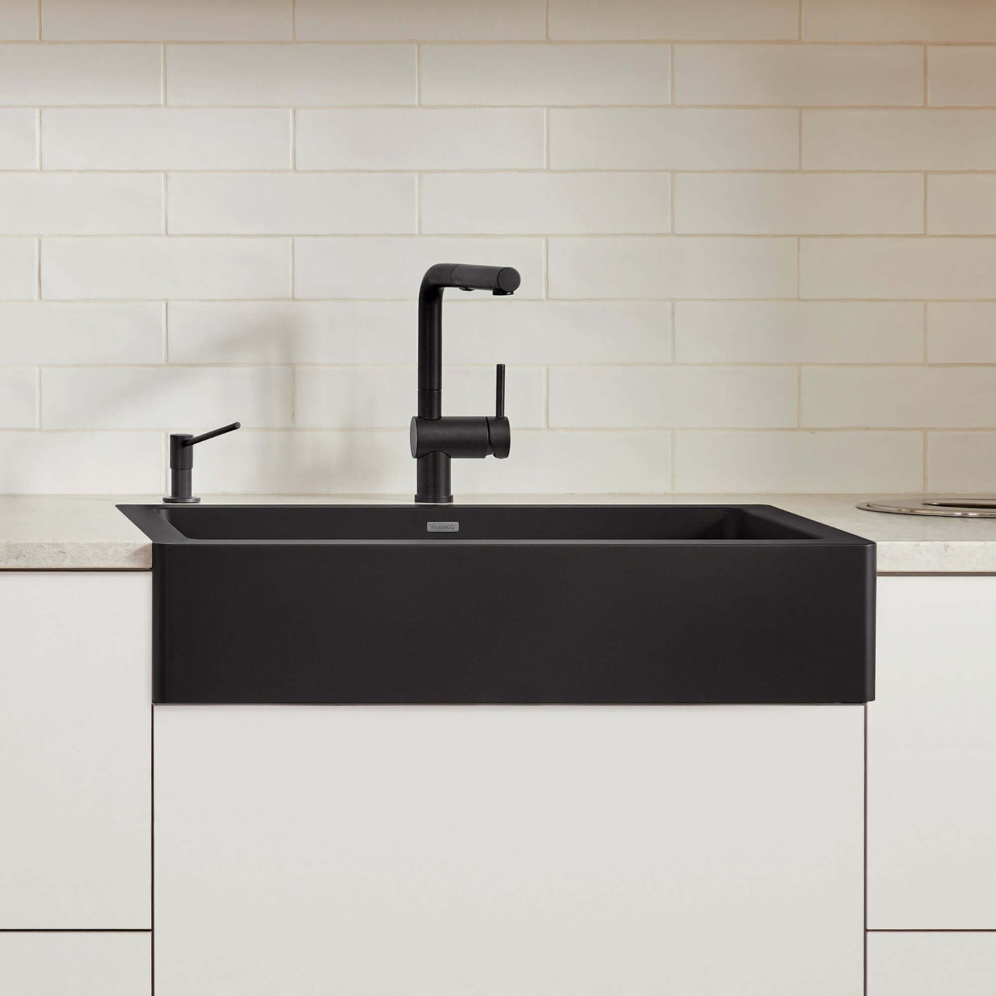 BLANCO VINTERA 30" SILGRANIT Single Bowl Farmhouse Sink in a modern kitchen setup with sleek black faucet.