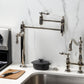 Kingston Brass KS3703AL Restoration Deck Mount Pot Filler Faucet, Antique Brass in a modern kitchen setting.