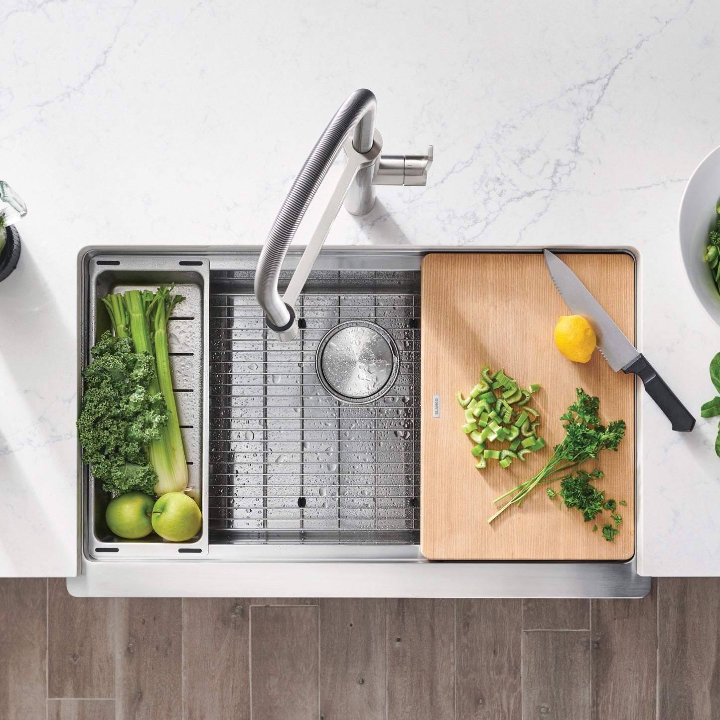 BLANCO Quatrus R15 Ergon 33" Single Bowl Apron-Front Stainless Steel Farmhouse Sink with cutting board and vegetables.