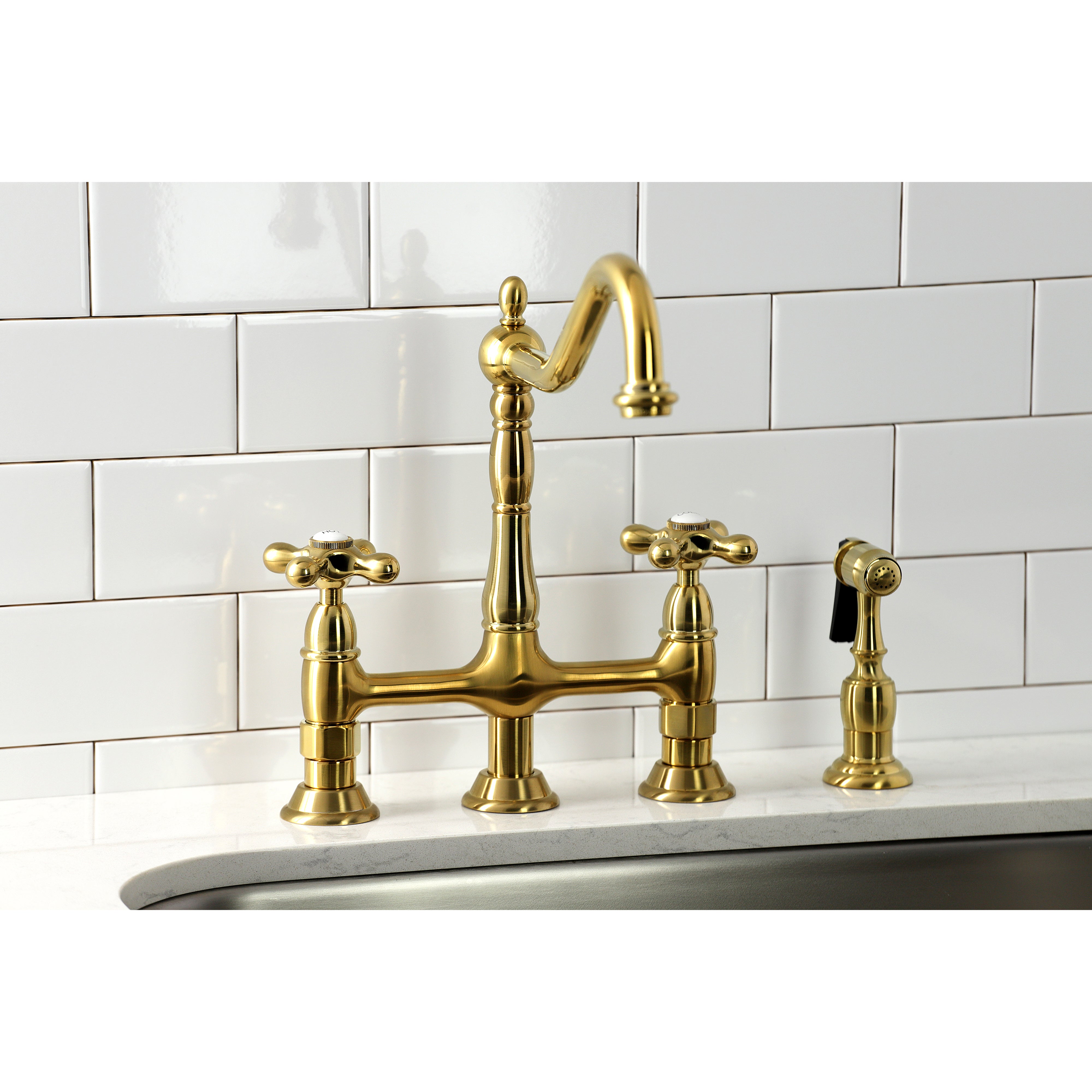 Kingston KS1273AXBS Heritage Bridge Kitchen Faucet with Brass Sprayer, Antique Brass on a kitchen sink