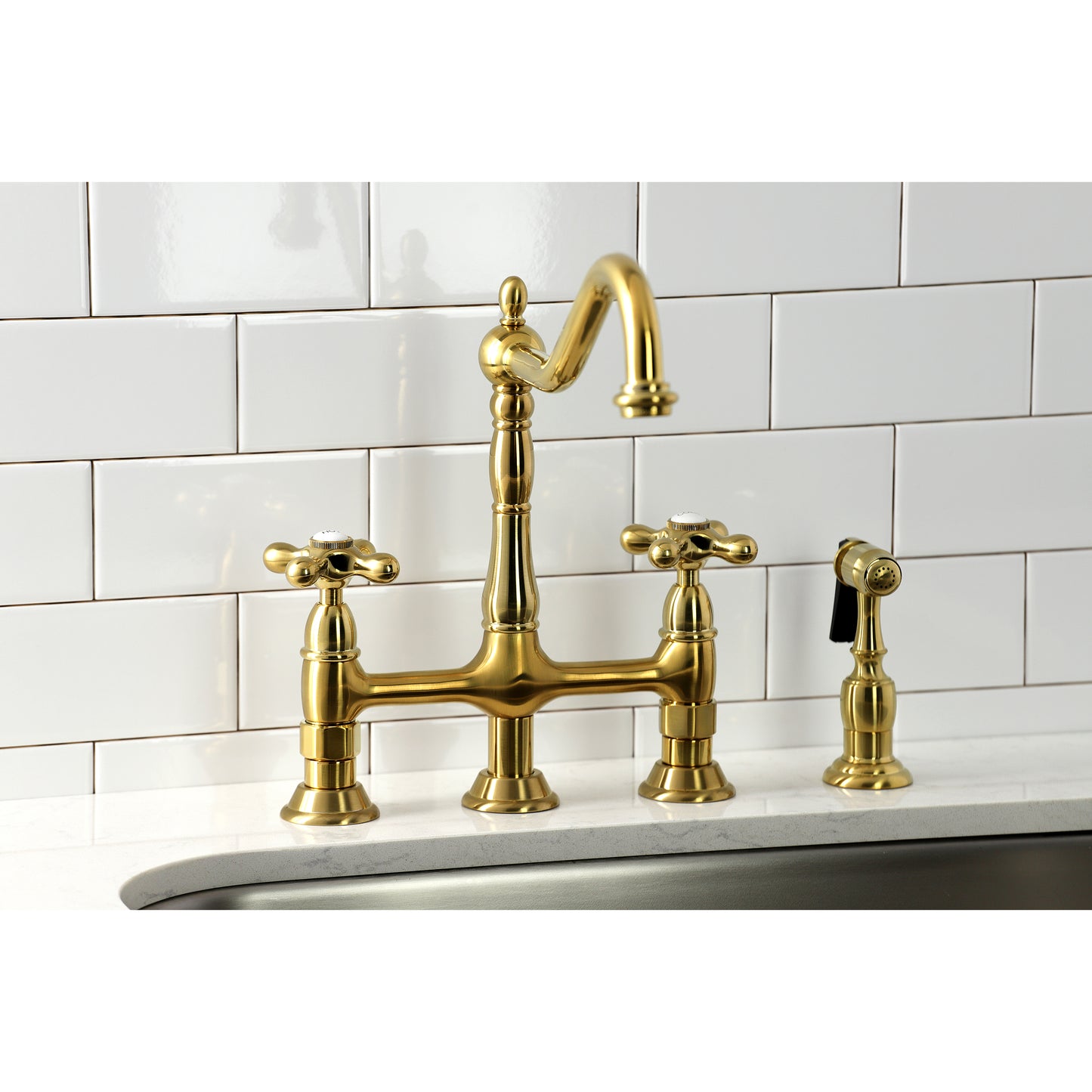 Kingston KS1273AXBS Heritage Bridge Kitchen Faucet with Brass Sprayer, Antique Brass on a kitchen sink