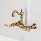 Kingston KS2443BAL Heirloom Two-Handle Wall Mount Bridge Kitchen Faucet, Antique Brass showing hot and cold handles.