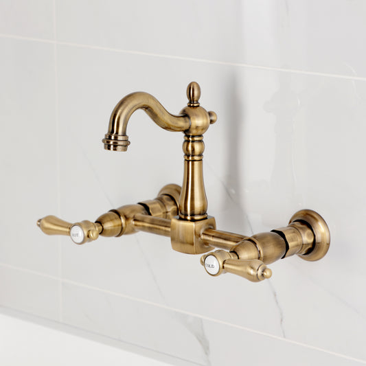 Kingston KS2443BAL Heirloom Two-Handle Wall Mount Bridge Kitchen Faucet, Antique Brass showing hot and cold handles.
