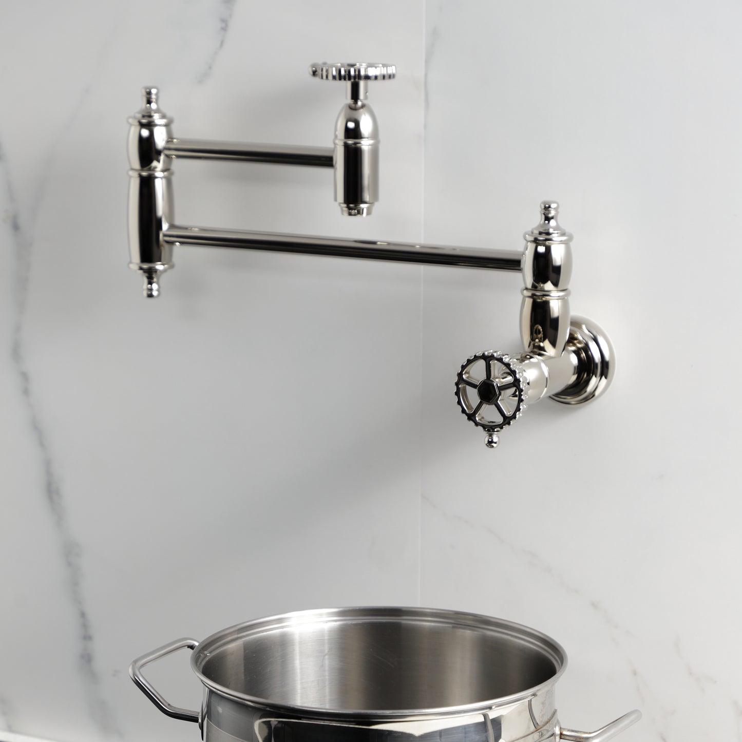 Kingston Brass KS3103CG Fuller Wall Mount Pot Filler Faucet, Antique Brass in a modern kitchen setting