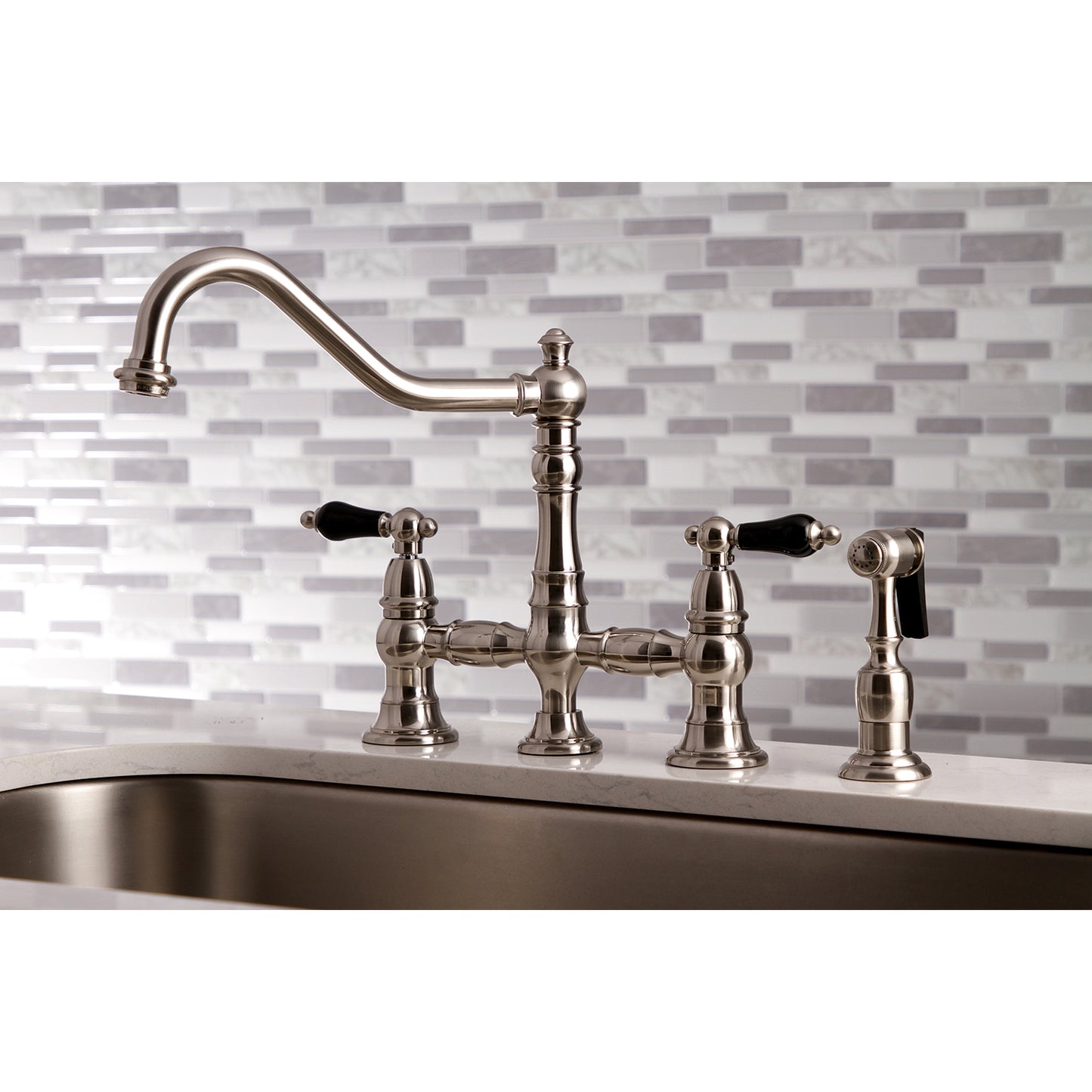 Kingston KS3277PKLBS Duchess Bridge Kitchen Faucet with Brass Sprayer, Brushed Brass on marble countertop.