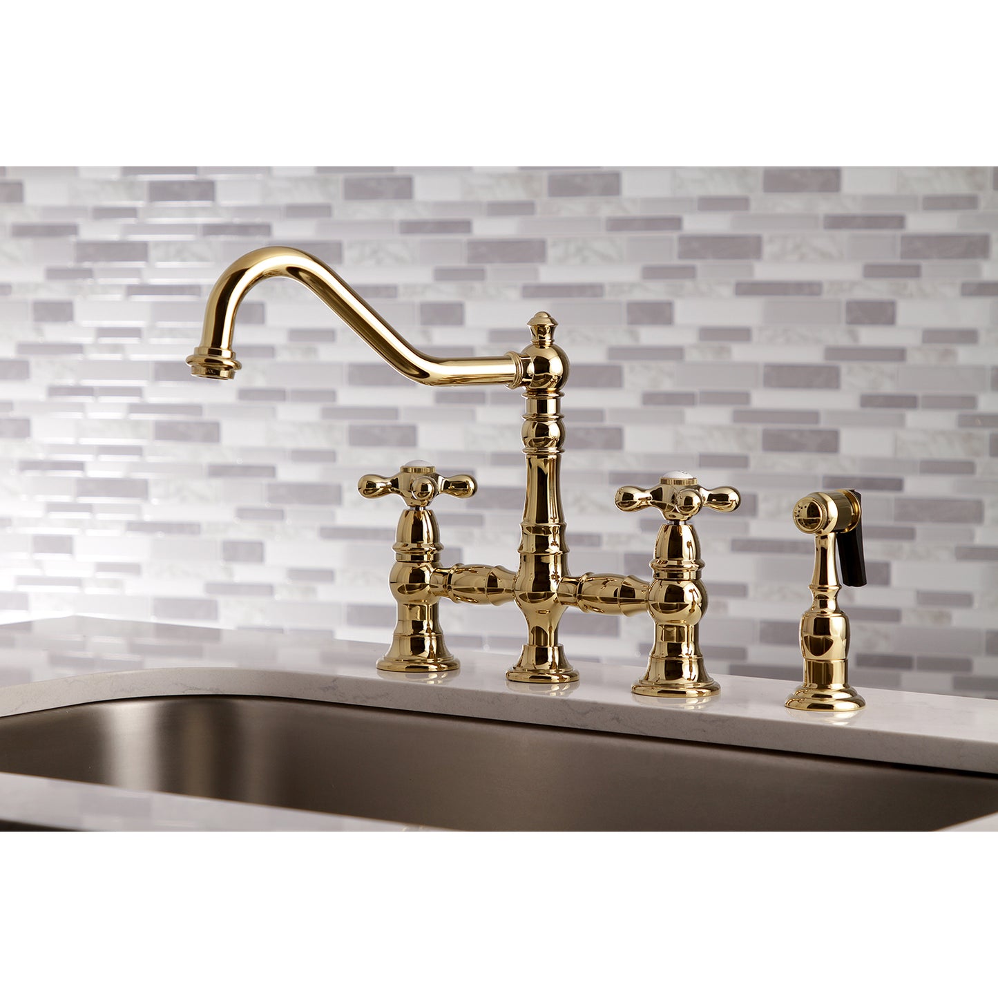 Kingston KS3277AXBS Restoration Bridge Kitchen Faucet with Brass Sprayer, Brushed Brass on decorative backsplash.