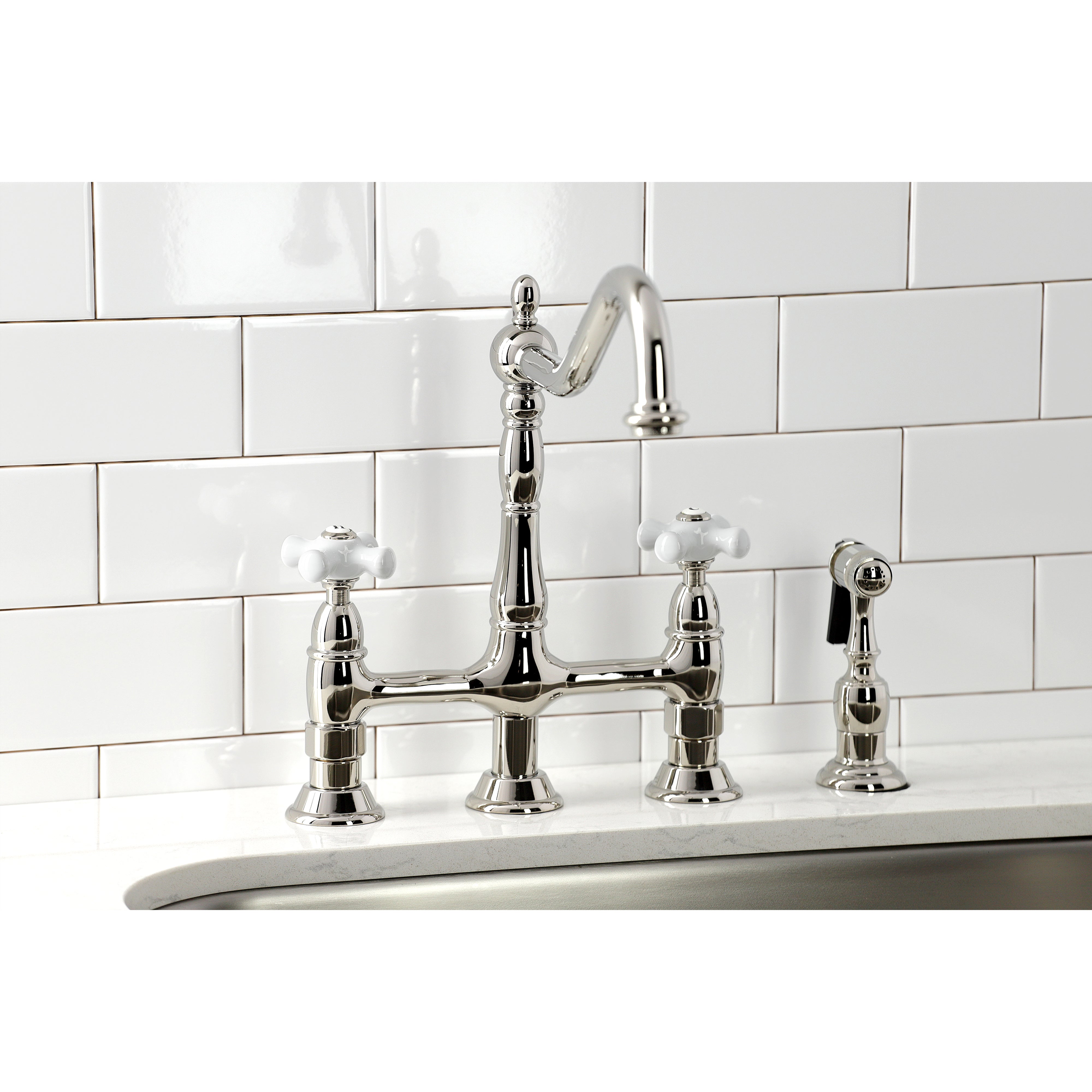 Kingston Brass Heritage Bridge Kitchen Faucet with Brass Sprayer and Cross Handles in polished chrome finish