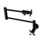 Kingston Brass KS4103BX Metropolitan Wall Mount Pot Filler Faucet, Antique Brass with matte black finish and foldable swing arms.