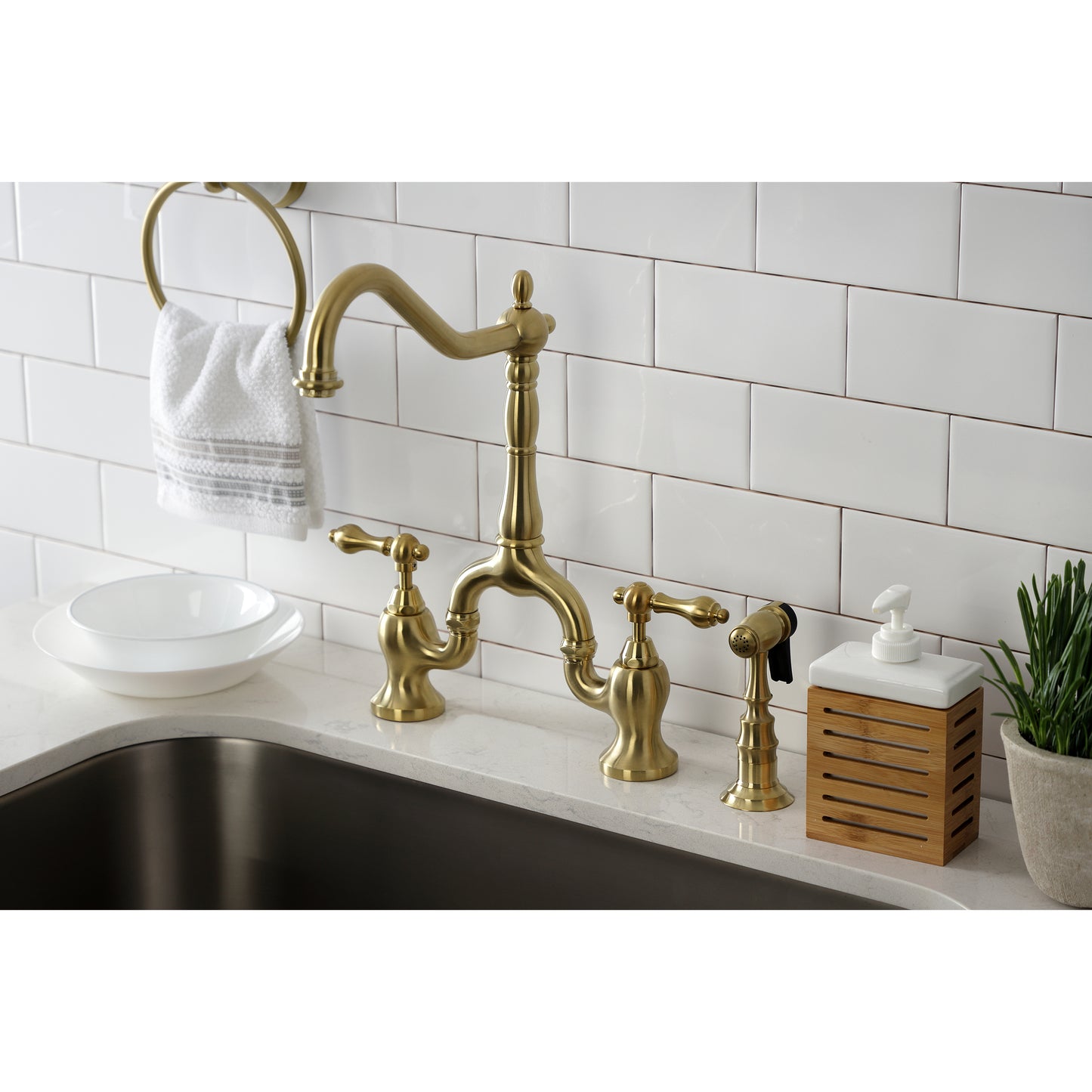 Kingston KS7757ALBS English Country Bridge Kitchen Faucet with Brass Sprayer, Brushed Brass in a kitchen setting