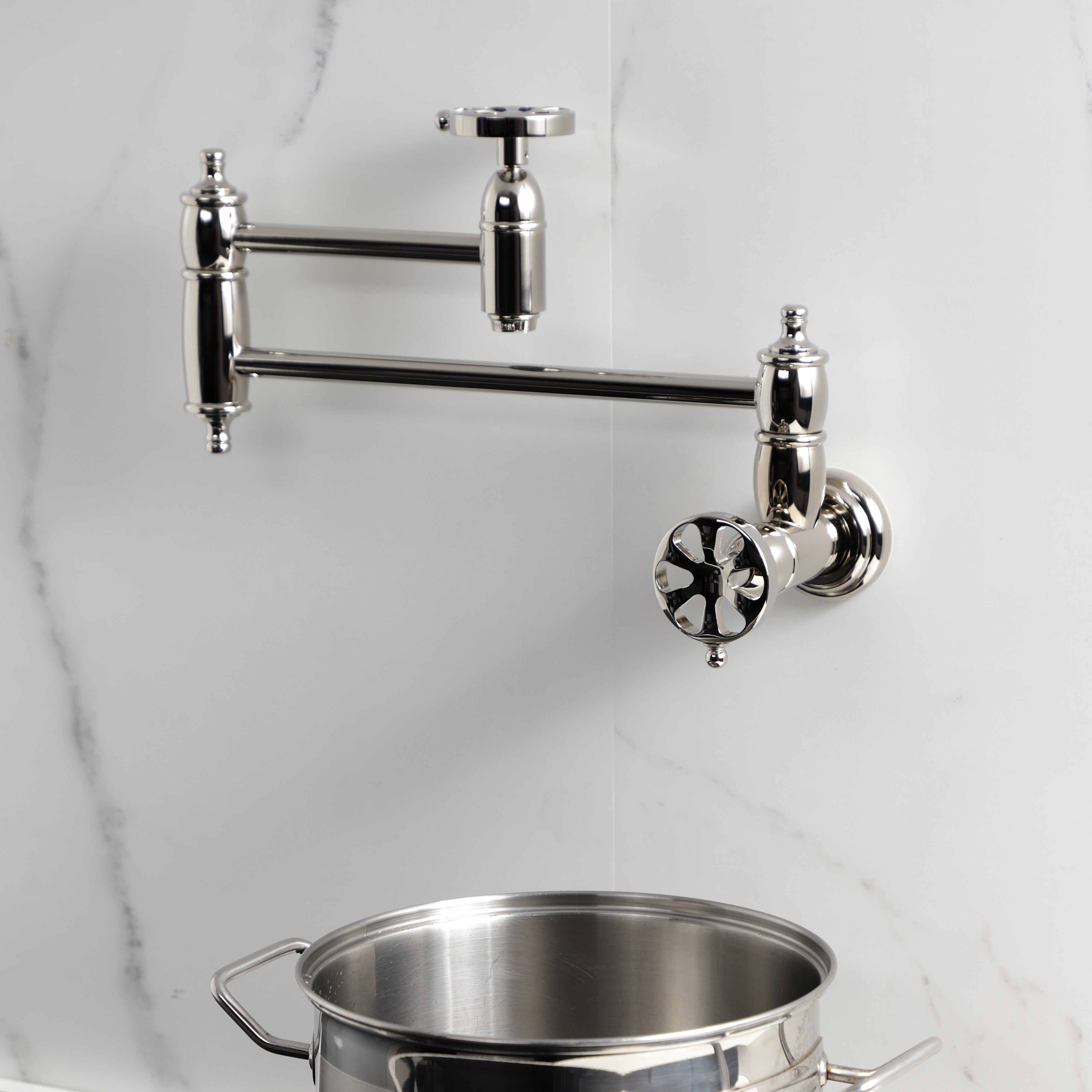 Kingston Brass KS3103RX Belknap Wall Mount Pot Filler Faucet, Antique Brass in modern kitchen setting with pot
