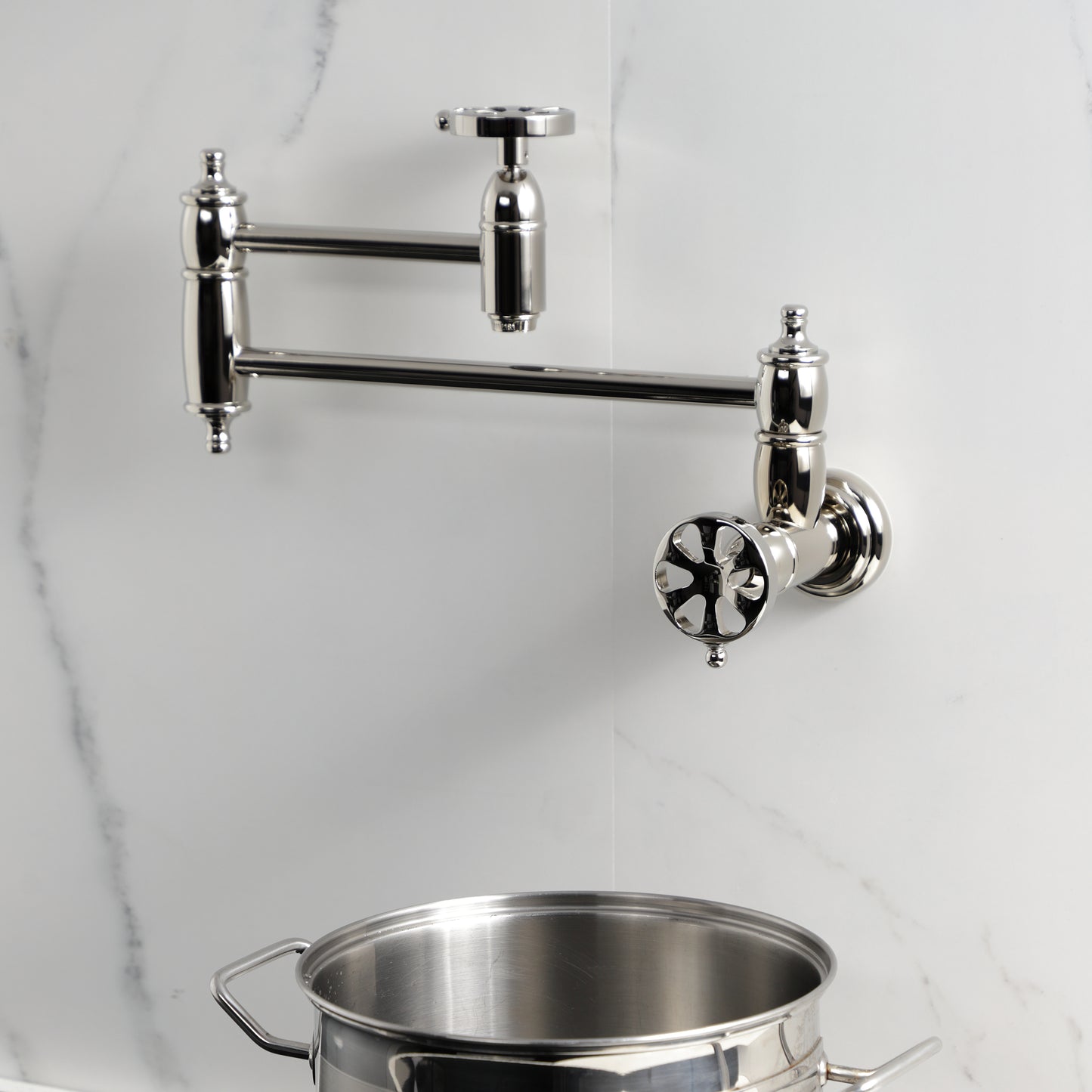 Kingston Brass KS3103RX Belknap Wall Mount Pot Filler Faucet, Antique Brass in modern kitchen setting with pot