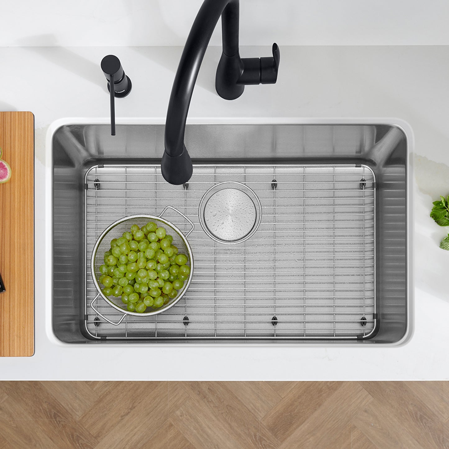 BLANCO Formera 28" Single Bowl Undermount Stainless Steel Kitchen Sink with grapes in a colander.