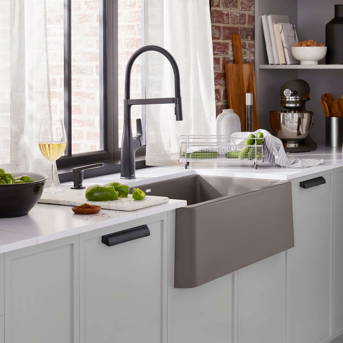BLANCO Ikon SILGRANIT 33" Single Bowl Apron-Front Farmhouse Sink in a modern kitchen with fresh ingredients and stylish faucet.