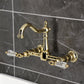 Kingston KS1263WLL Willshire Two-Handle Wall Mount Bridge Kitchen Faucet, Antique Brass on grey tiled wall.