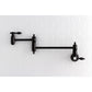 Kingston Brass KS3103TAL Tudor Wall Mount Pot Filler Faucet, Antique Brass against white subway tile backdrop.