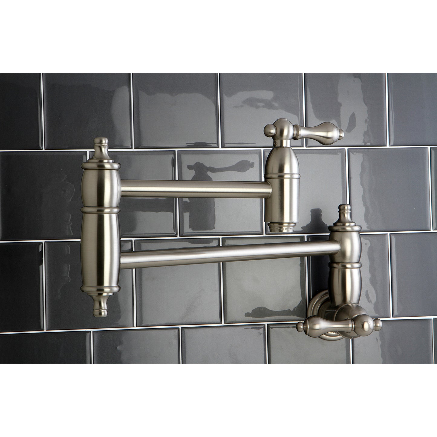 Kingston Brass KS3103AL Restoration Wall Mount Pot Filler Faucet, Antique Brass on a modern tile backsplash.