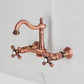 Kingston KS1263AX Heritage Two-Handle Wall Mount Bridge Kitchen Faucet, Antique Brass in copper finish