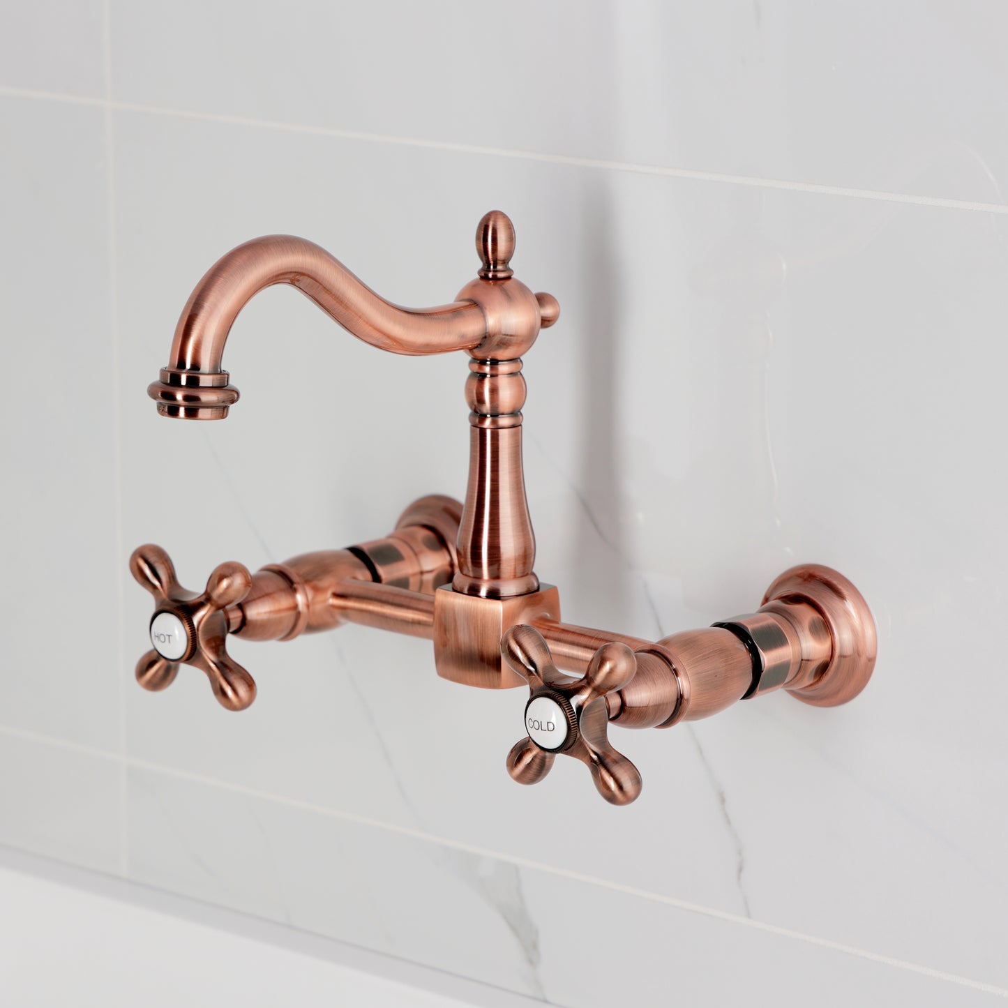 Kingston KS1263AX Heritage Two-Handle Wall Mount Bridge Kitchen Faucet, Antique Brass in copper finish