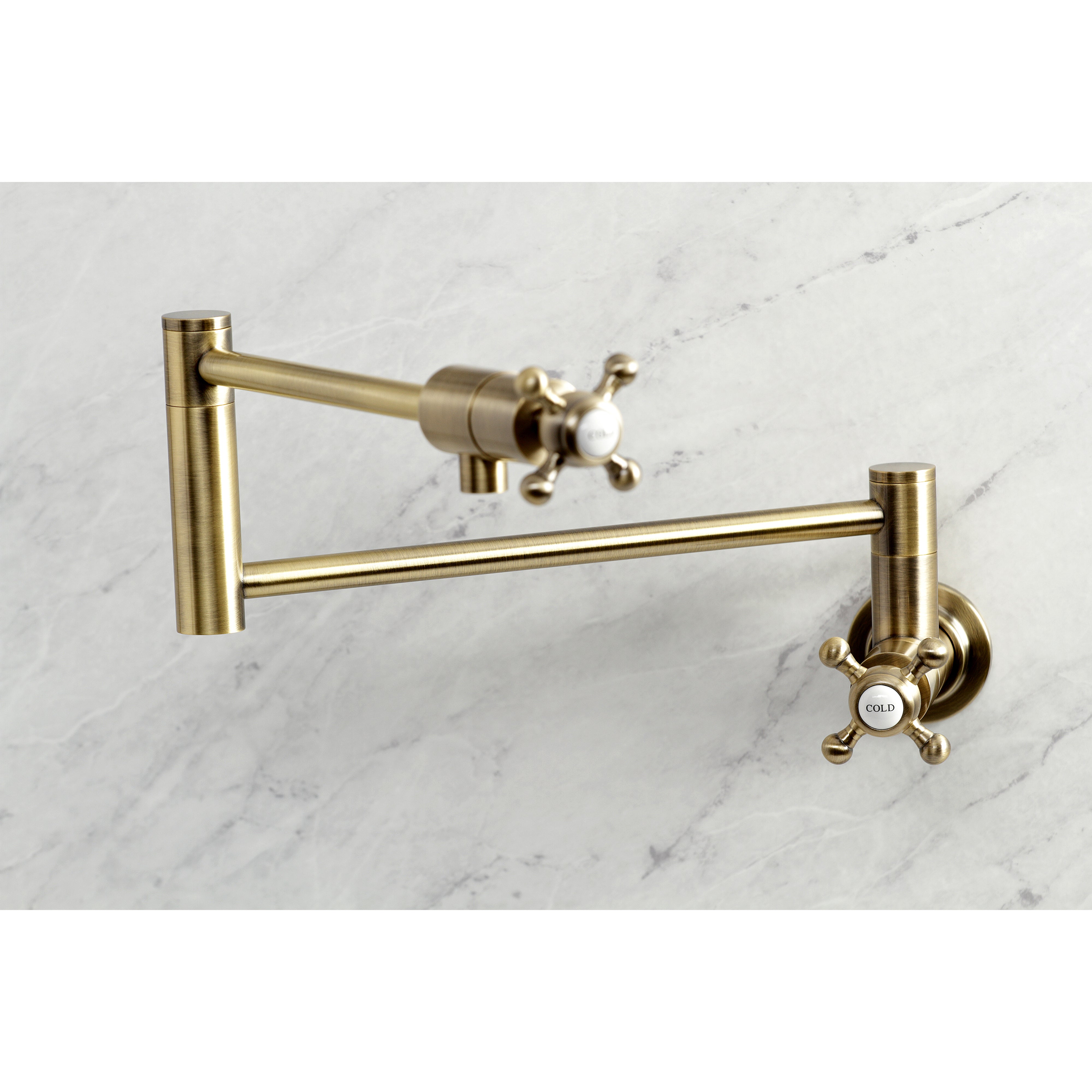 Kingston Brass KS4103BX Metropolitan Wall Mount Pot Filler Faucet, Antique Brass on a marble background.