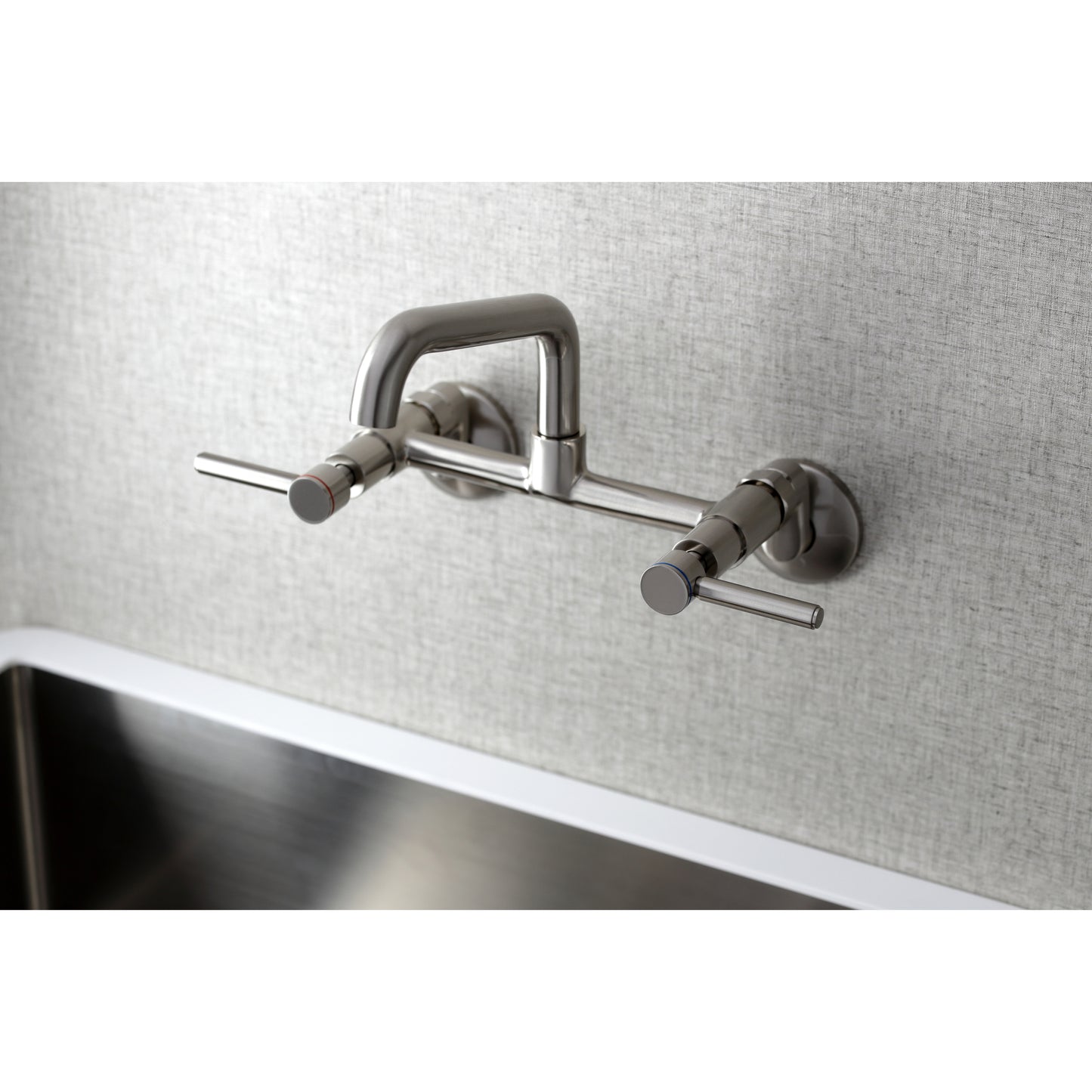Kingston Brass KS823SB Concord Wall Mount Bridge Kitchen Faucet in sleek design over a stainless steel sink.