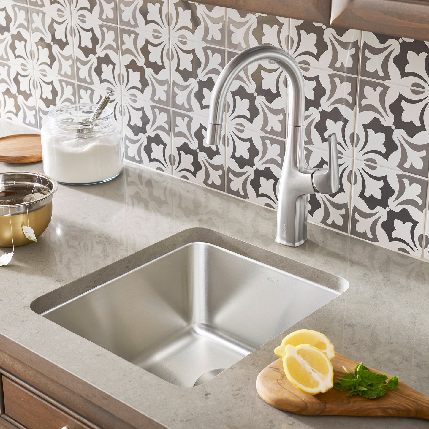 BLANCO Formera 16" Undermount Stainless Steel Bar Sink with modern faucet and lemon on countertop.