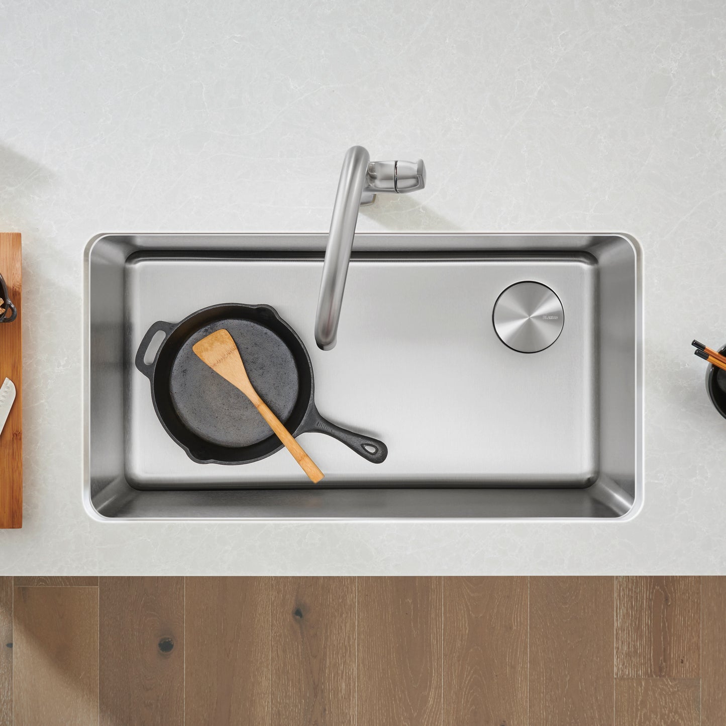 BLANCO Formera 33" Super Single Undermount Stainless Steel Kitchen Sink with pot and wooden spoon on counter.