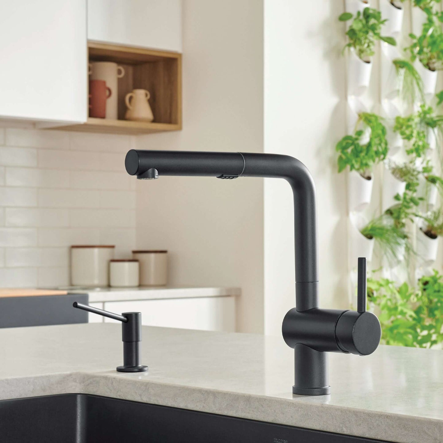 BLANCO Linus Low Arc Pull-Out Dual-Spray Kitchen Faucet - in a modern kitchen setting with plants.