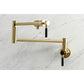 Kingston Brass KS4103DKL Kaiser Wall Mount Pot Filler Faucet, Antique Brass on a marble background.