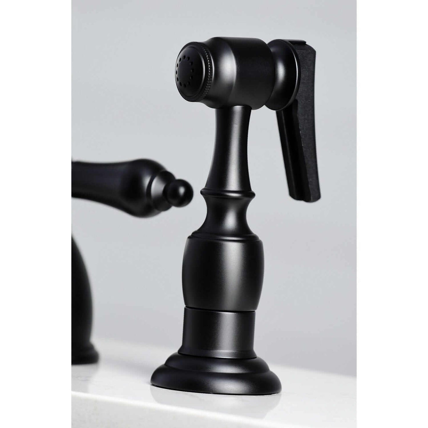 KINGSTON Brass Widespread Kitchen Faucet with Brass Sprayer - KB1790ALBS close-up view of the brass sprayer handle