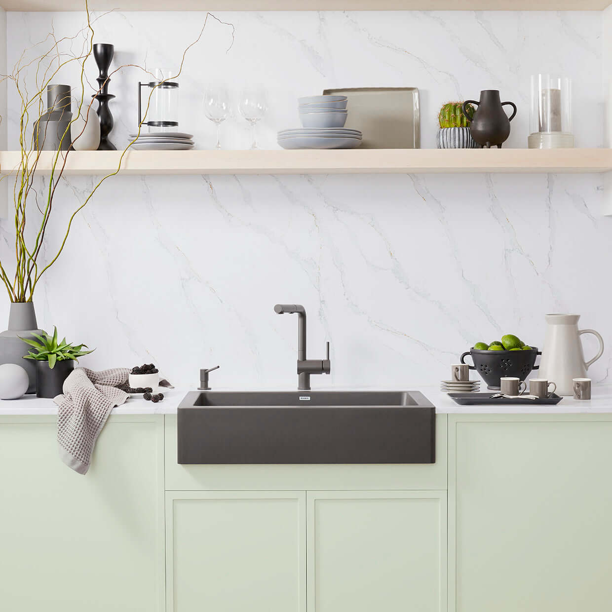 BLANCO Linus Low Arc Pull-Out Dual-Spray Kitchen Faucet - installed in a stylish modern kitchen with green cabinetry.