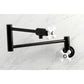 Kingston Brass KS4107PX Metropolitan Wall Mount Pot Filler Faucet, Brushed Brass, featuring swing arms and white knobs.