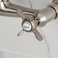 Kingston KS3253BEX Essex Two-Handle Wall Mount Bridge Kitchen Faucet, Antique Brass cold water handle close-up