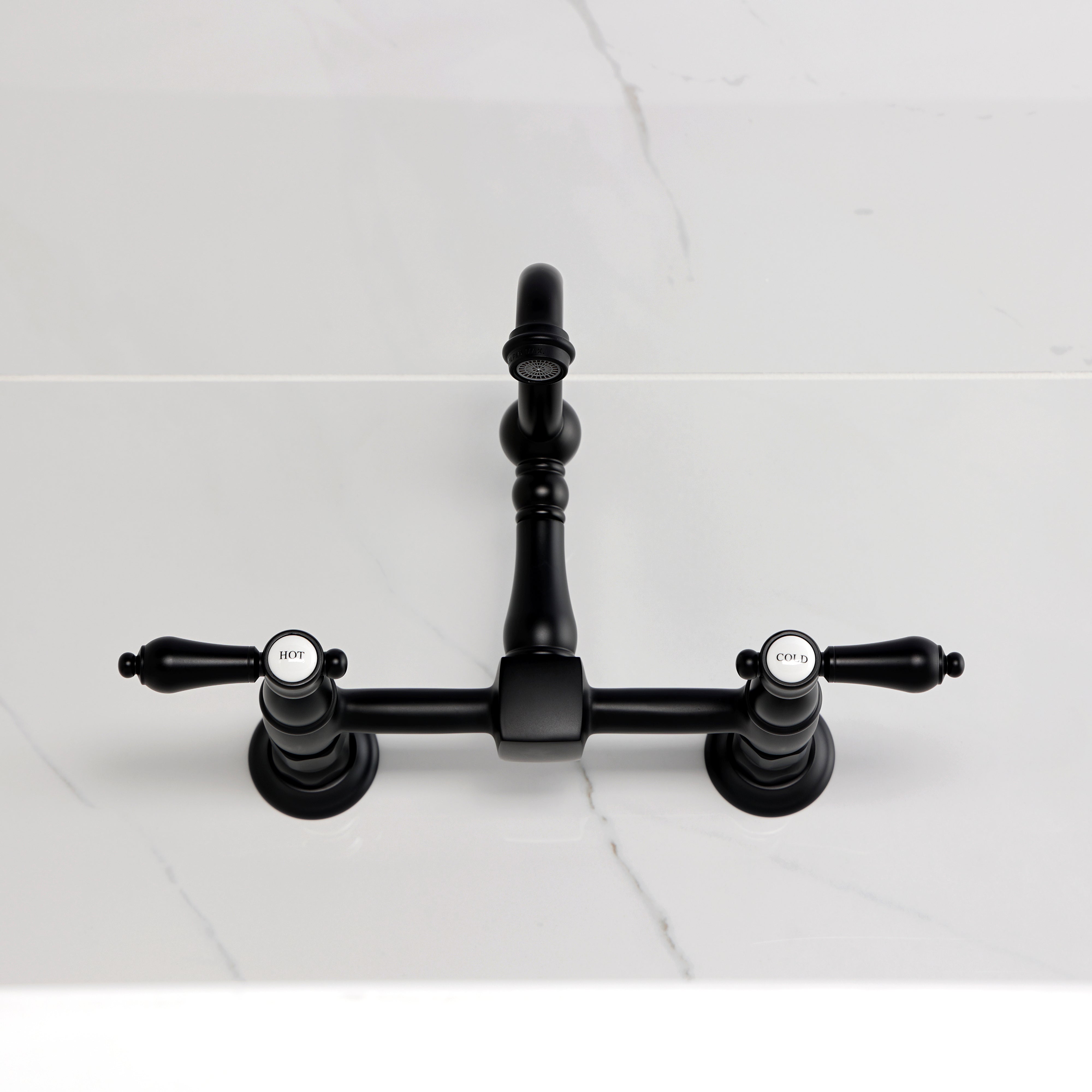 Kingston KS2443BAL Heirloom Two-Handle Wall Mount Bridge Kitchen Faucet, Antique Brass on countertop