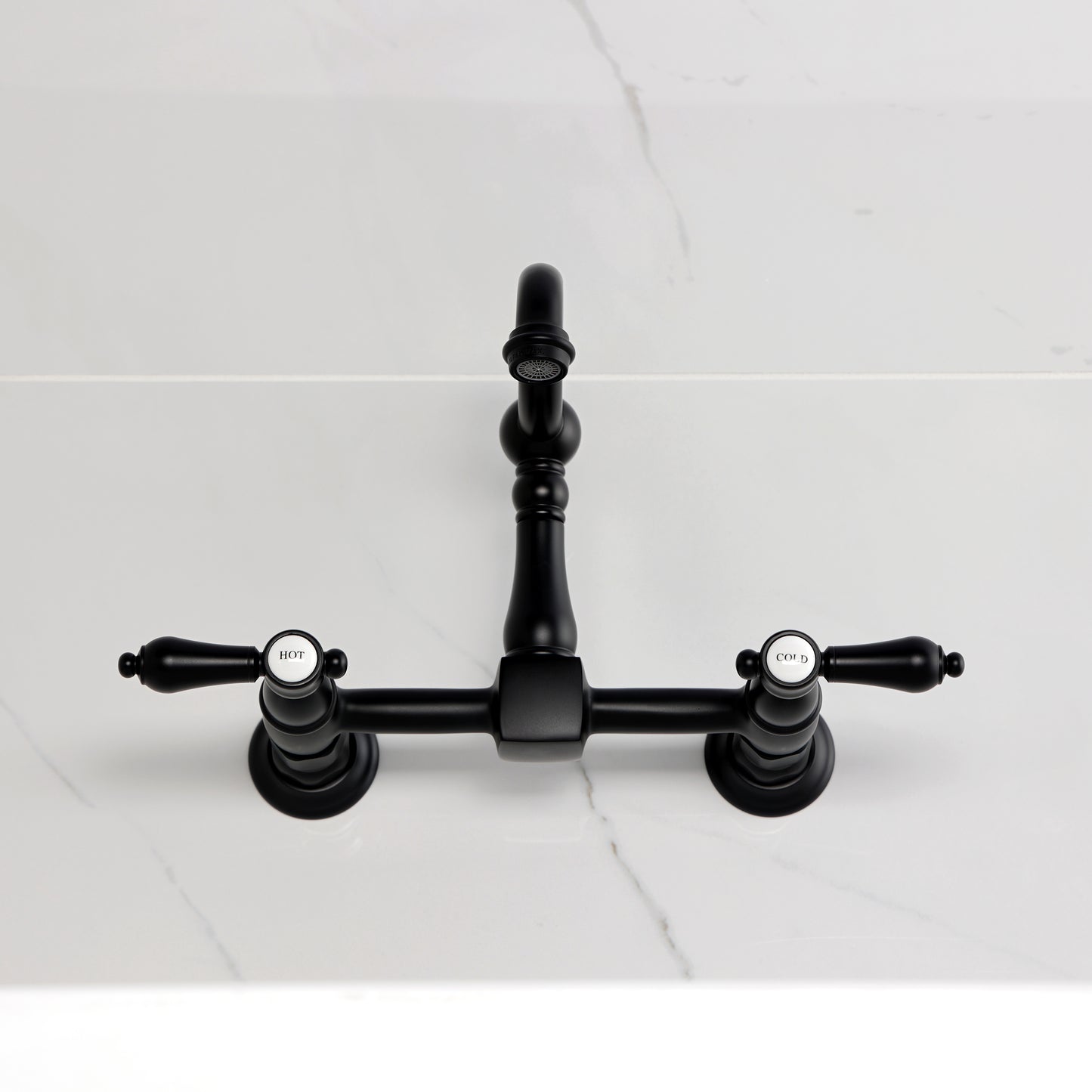 Kingston KS2443BAL Heirloom Two-Handle Wall Mount Bridge Kitchen Faucet, Antique Brass on countertop