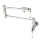 Kingston Brass KS4107PL Metropolitan Wall Mount Pot Filler Faucet, Brushed Brass with foldable swing arms and white levers.