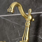 Kingston KS2443AX Heritage Two-Handle Wall Mount Bridge Kitchen Faucet, Antique Brass spout detail on marble background