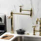 Kingston Brass KS3703AX Restoration Deck Mount Pot Filler Faucet, Antique Brass on a countertop beside a stovetop.
